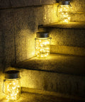 Hanging Mason Jar Solar Lights 6 Pack With 30 LED Lanterns illuminating stone steps outdoors, showcasing waterproof design.