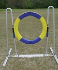 Pro Grade Durable Dog Agility Tire Jump With Non Rust Aluminum Frame For Smooth Quick Reset On Impact Outdoor Field Ready Training Gear For Competitive Courses And Home Practice, yellow and blue tire on grass field.