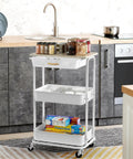 3 Tier Rolling Utility Cart With Drawer And Wood Tabletop Maple Finish in kitchen setup with storage items