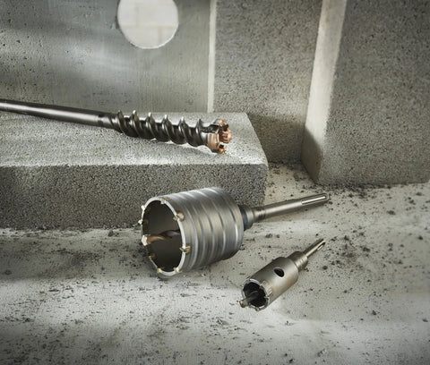 Beefy SDS Max Rotary Hammer Core Bit 4 In By 12 In With Wave Design and carbide centering tip on concrete surface