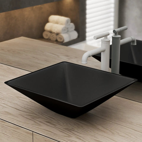 Claire 15.5 Inch Black Glass Vessel Sink for above counter mount with white faucet, showcasing sleek modern style in bathroom.