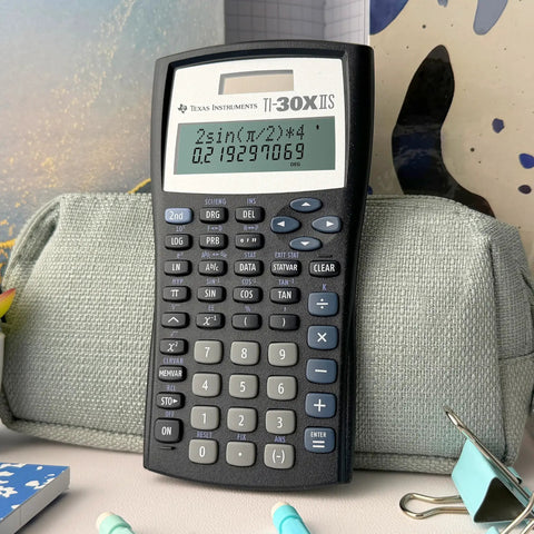 Legit Game Changing Scientific Calculator Featuring Two Line Display Advanced Statistics And Quick Fraction Conversions on a desk.