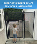 Child observing Hella Sturdy Pool Fence Wall Mount Kit For Inground Swimming Pools featuring a mesh gate with proper tension.