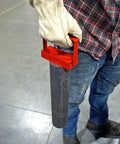 Person using Red 150 Lb Pull Heavy Duty Handle Magnet for tools to lift metal rod on workshop floor.