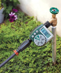 Image of a garden faucet with 3-In-1 Drip Irrigation Faucet Adapter With Filter, Pressure Regulator And Drip-Lock, hose connected.