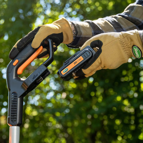 Inserting battery into 20V Cordless Garden Tiller Cultivator With 7.5 Inch Width, 6 Inch Depth, 4 Steel Tines outdoors
