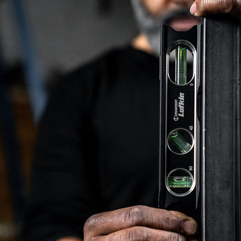 Person holding Lufkin Aluminum Billet Level With Large Main Vial, Full Aluminum Body For Drop Protection, Rare Earth Magnets Embedded In Frame