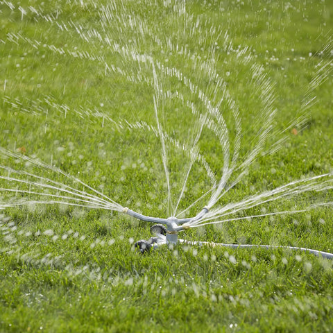 Heavy Duty Spinning Sprinkler With Wheeled Base For 360 Degree Coverage In Flower Beds And Vegetable Gardens, Metal Whirling Head Delivers Gentle Rain Like Spray, Reduces Water Pooling, Easy Move Across Lawn spraying water on grass