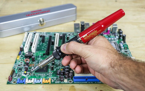 Hand using Ultratorch UT-50 Pen Sized Butane Powered 3 In 1 Heat Tool Soldering Iron Flameless Heat Tool And Pinpoint Torch