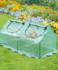 Six By Three Foot Mini Greenhouse Kit With All Season 3 In 1 Design featuring triple-layer windows in a garden setting