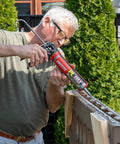 Man applying Heavy Duty Construction Adhesive For Wood Concrete Stone And More Premium Max Strength Bond That Stays 100 Percent Solid After Curing In A 9 Oz Cartridge 1 Pack on outdoor structure