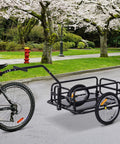 Foldable Bike Cargo Trailer With Hitch Tow-Behind Wagon, 88 Lb Capacity, Black Utility Cart attached to bike near cherry blossoms