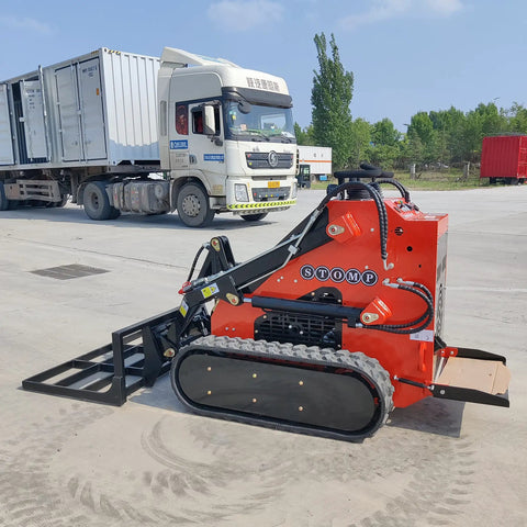 Small But Mighty Mini Skid Steer Loader With Leveler, 1800lbs Capacity, parked on concrete, ideal for gardens and roads.
