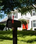 Cast Aluminum Heavy Duty Adjustable Mailbox Post Black With Weatherproof Powder Coat Finish Resists Rust Height From 33 To 41 Inches Supports Up To 120 Lbs Fits Over 4x4 Post CP000B00 in front of a house