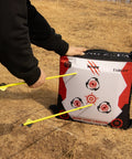 Person using durable portable bag archery target 40x40 with high density core and removable inner core refills for recurve and compound bow outdoor practice at the range.