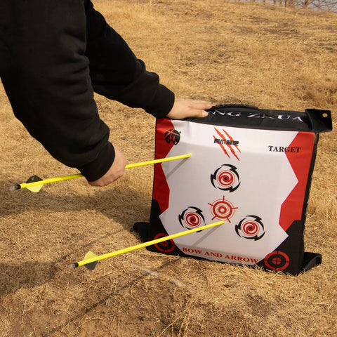Person using durable portable bag archery target 40x40 with high density core and removable inner core refills for recurve and compound bow outdoor practice at the range.