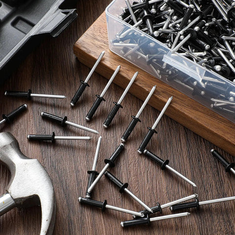 200 Pack 3/16 Inch Head Aluminum Tri Grip Exploding Pop Rivets for marine uses scattered on wooden surface