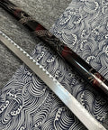 Close-up of a sword blade and sheath from Red 3 Piece Samurai Sword Set With Display Stand Katana Collection Decorative Swords.