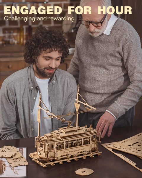 3D Wooden Puzzle Kit for Adults, Mechanical Tram Model 1:24 Scale, Car Model Replica, Intricate Gear System, Build Time About 5 Hours, Wood Building Craft, Unique Gift for Puzzle Fans and Hobbyists with two men assembling a wooden tram