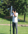 Person using a Heavy Duty 24 Inch Post Driver Rammer For Installing Fence Posts Up To 2.5 Inches With Ergonomic Closed Handles