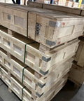 Stacked wooden crates in a warehouse, designed for heavy loads, showcasing strong construction and materials.