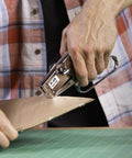 Person using Heavy Duty Handheld Plier Stapler Makes Stapling Paper Bags Thin Plastics Cardboard A Breeze With Its Tough Build And Comfortable Grip Handles Perfect For Office Shops Home Crafts And Insulation Jobs Using One Fourth And Three Eighth Inch Staples on cardboard