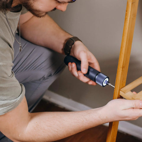 Person using MI HOTO Cordless Power Electric Screwdriver With LED Shadow Light to assemble wooden furniture