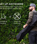 Man carrying Adjustable Portable Hammock Stand For 9 To 14 Ft Hammocks, Outdoor Patio Steel Frame in a black carrying bag