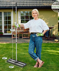 Woman standing with Pro-Grade Heavy-Duty Lawn Leveling Rake, 30x10 inch aluminum roller base, adjustable 27 to 80 inch stainless steel handle