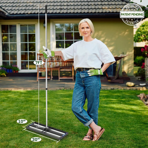 Woman standing with Pro-Grade Heavy-Duty Lawn Leveling Rake, 30x10 inch aluminum roller base, adjustable 27 to 80 inch stainless steel handle