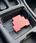 No Hassle Automatic Aerosol Fire Extinguisher 2 Pack Dual Nozzle units in a car cup holder.