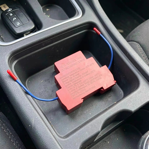 No Hassle Automatic Aerosol Fire Extinguisher 2 Pack Dual Nozzle units in a car cup holder.