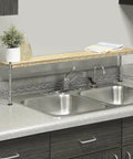 Space Saver Sink Shelf With Wood And Chrome Finish over kitchen sink with plants and towels, instant above sink storage.
