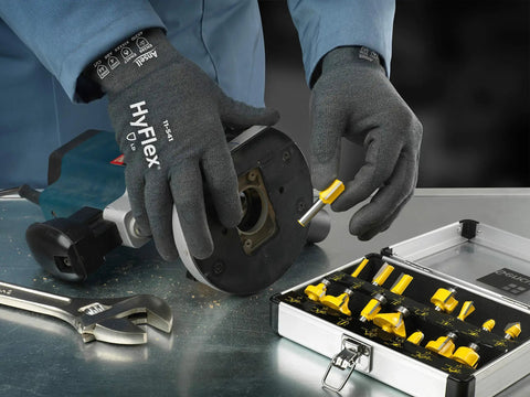 Person wearing Cut Resistant Work Gloves With Ultra Dexterity And All-Day Comfort, ZONZ Knit For Flexible Movement, handling tools.