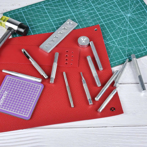 14-Piece Rivet Setter Kit For Leather Work Pro-Grade Stainless Steel Snap Rivet Tools with Non-Slip Base on red leather surface