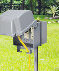 Extra Duty RaynGuard Metal Weatherproof In Use Cover for Outdoor 2 Gang Electrical Outlets in gray, mounted on post.