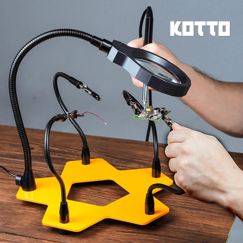 LED Lighted Magnifying Third Hand Soldering Station with Five Adjustable Arms in use for holding PCB, bright LED lamp, yellow base.