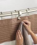 Brushed Nickel Adjustable 57 To 60 Inch Stainless Steel Double Curved Shower Curtain Rod With Wall Fixed Brackets, hand holding towel