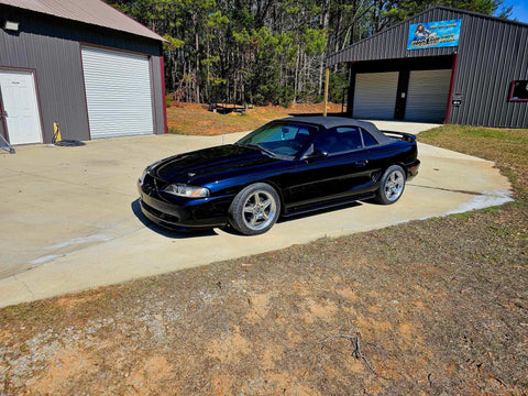 Top Shelf Tinted Blue Paint Basecoat Gallon Ready To Spray With Slow Reducer Blend For Ultra Smooth Automotive Finish That Hits Perfect And Looks Totally Fresh On Any Ride parked outside a garage.