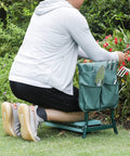Person using Folding Garden Kneeler Seat With Handles And Pouch, Heavy Duty Yard Chair With Soft Kneeling Pad, in garden
