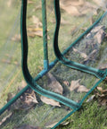 Close-up of 11 By 3 By 2.5 Ft Mini Greenhouse Portable Tunnel with UV waterproof clear plastic cover and steel frame on grass