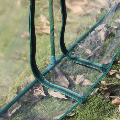 Close-up of 11 By 3 By 2.5 Ft Mini Greenhouse Portable Tunnel with UV waterproof clear plastic cover and steel frame on grass