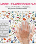 Close-up of Ultra Large Desk Pad For Desktop 31.5 Inch By 11.8 Inch Extended Mouse Pad With Anti Slip Surface Featuring Wildflowers with a hand using a mouse.