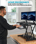 Man using PowerPro 36 Inch Electric Standing Desk Converter For Sit To Stand With Height Adjustable Riser Dual Monitor Desktop Workstation in black