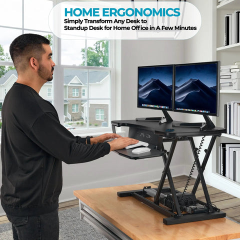 Man using PowerPro 36 Inch Electric Standing Desk Converter For Sit To Stand With Height Adjustable Riser Dual Monitor Desktop Workstation in black