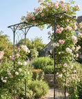 Steel Garden Arch For Climbing Plants 6 Ft 9 In High By 4 Ft 11 In Wide Weather Resistant Black Epoxy Finish Outdoor Yard Arbor Built To Show Off Vines And Flowers Easy Setup For Your Patio Garden Lawn Backyard with pink roses in a lush garden setting.