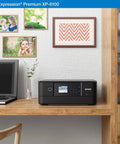Slick Wireless Color All In One Inkjet Printer Featuring Killer Five Color Photo System For Crisp Documents And Legit Eight By Ten Prints Perfect For Your Home Office Setup Or Creative Project Workflow on a wooden desk with photos and laptop.