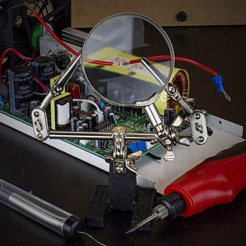 Adjustable Soldering Helping Hand With Pro Grade Magnifying Glass Third Hand Solder Aid Wire Station Stand with circuit board.