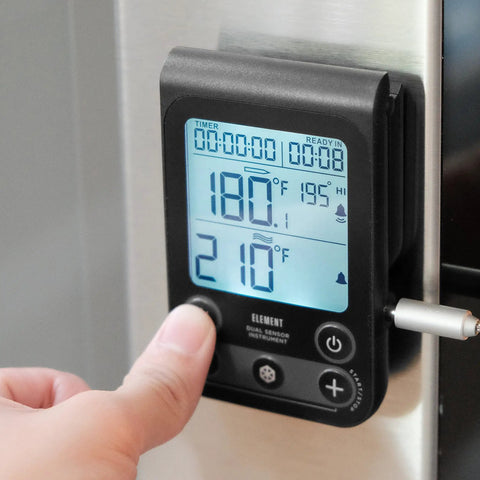 Dual Sensor Digital Oven Thermometer For Oven Grill And Smoker with programmable temperature display, being set on appliance.