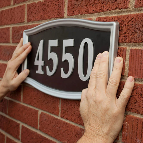 Hands using Heavy Duty Double Sided Mounting Tape Weatherproof 1 Inch By 60 Inch Black Pack Of 3 That Holds Up To 30 Pounds to mount sign